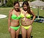 Couple of teen Latinas in green bikinis have bulges